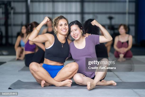 feeling strong - group of people flexing biceps stock pictures, royalty-free photos & images