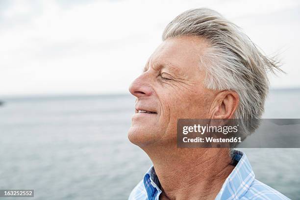 spain, senior man with closed eyes, close up - man smiling eyes closed stock pictures, royalty-free photos & images