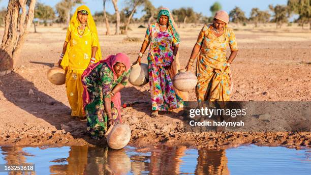 indian women collecting water from a lake, rajasthan - water shortage stock pictures, royalty-free photos & images