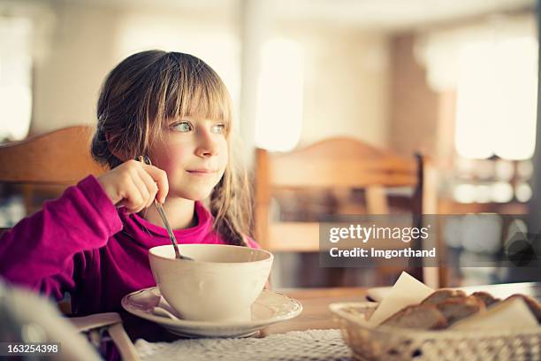 little girl eating soup - eating soup stock pictures, royalty-free photos & images