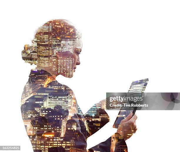 business woman using a tablet, and city at night. - double exposure business stock pictures, royalty-free photos & images