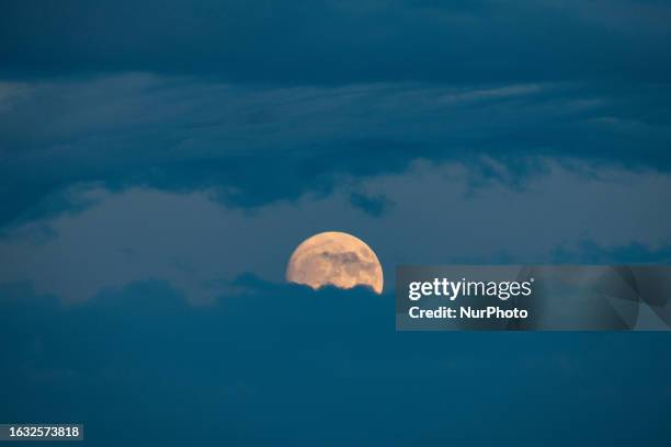 Crescent moon rises behind clouds in Andria, Puglia, Italy, on august 29, 2023. The full moon, also visible on august 30 and 31, will be the 2023...