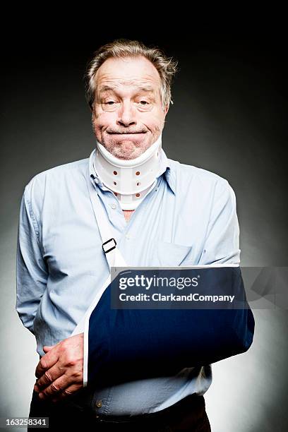 mature man with whiplash with neck brace and sling - cervical collar stock pictures, royalty-free photos & images