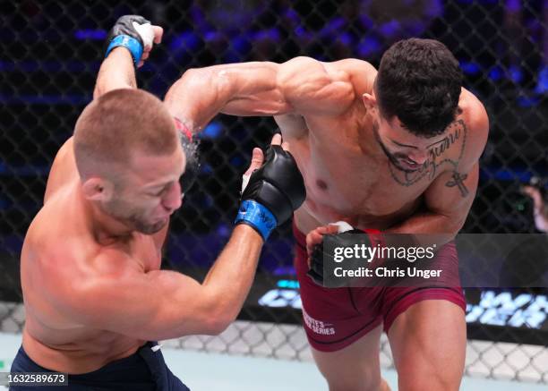 Kaik Brito of Brazil punches Oban Elliott of Wales in a welterweight fight during Dana White's Contender Series season seven, week three at UFC APEX...