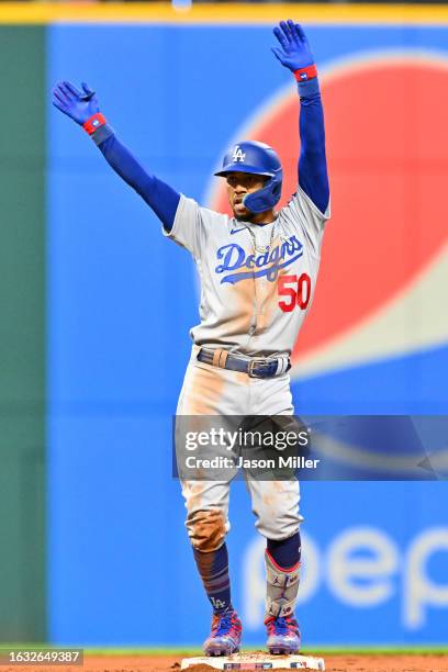 Mookie Betts of the Los Angeles Dodgers celebrates after hitting a double to left during the fifth inning against the Cleveland Guardians at...
