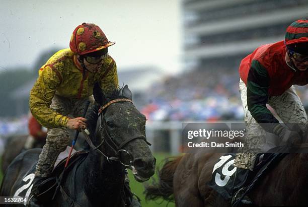 Two mud splattered riders and horses during a race at Royal Ascot \ Mandatory Credit: Dan Smith/Allsport