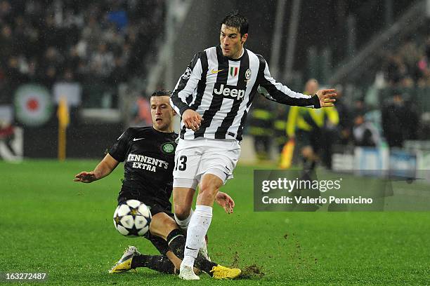 Federico Peluso of Juventus is tackled by Adam Matthews of Celtic during the UEFA Champions League round of 16 second leg match between Juventus and...