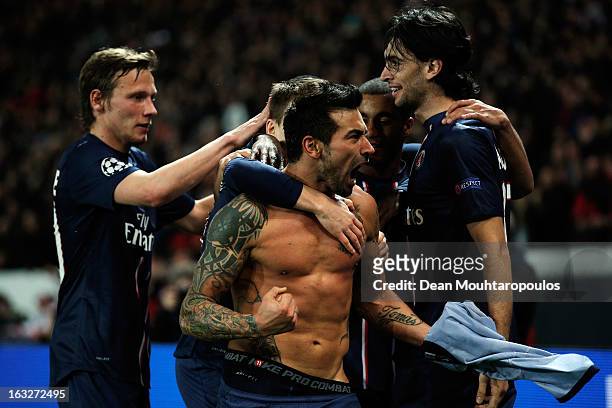 Ezequiel Lavezzi of PSG takes off his shirt and celebrates with team mates after he scores his team first goal during the Round of 16 UEFA Champions...
