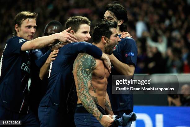 Ezequiel Lavezzi of PSG takes off his shirt and celebrates with team mates after he scores his team first goal during the Round of 16 UEFA Champions...