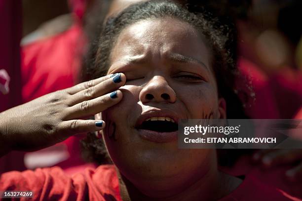 Supporter cries as she accompanies the funeral cortege of late Venezuelan President Hugo Chavez on its way to the Military Academy, on March 6 in...