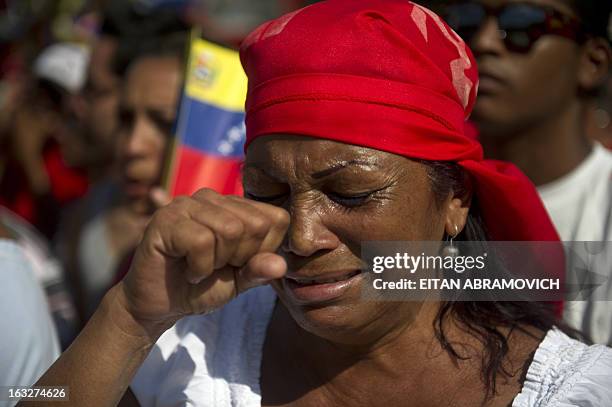 Woman cries as she accompanies the funeral cortege of late Venezuelan President Hugo Chavez on its way to the Military Academy, on March 6 in...