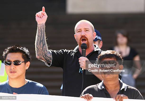 The Australian Manufacturing Workers Union's assistant secretary Leigh Diehm talks to protesters on the steps of State Parliament during a union...