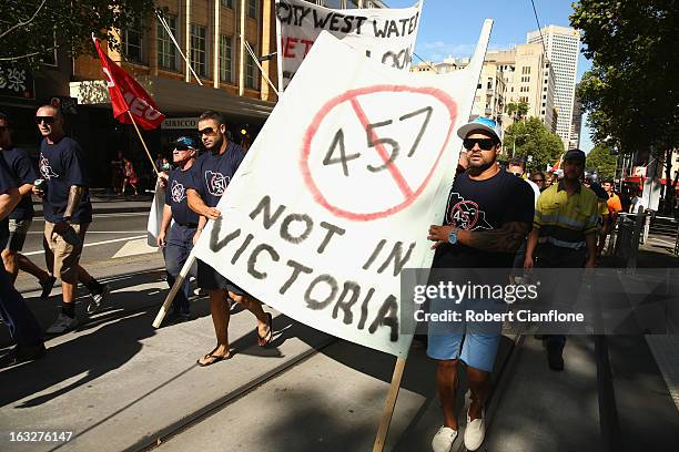 Workers walk through the city during a union organised protest against temporary worker visas on March 7, 2013 in Melbourne, Australia. As Australia...