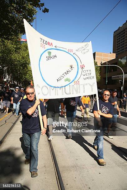 Workers walk through the city during a union organised protest against temporary worker visas on March 7, 2013 in Melbourne, Australia. As Australia...