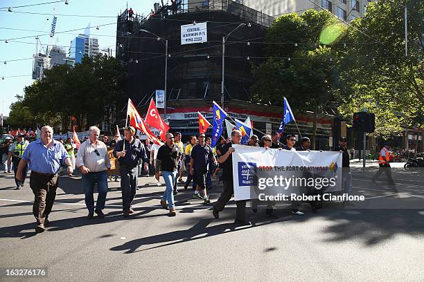 Workers walk through the city during a union organised protest against temporary worker visas on March 7, 2013 in Melbourne, Australia. As Australia...