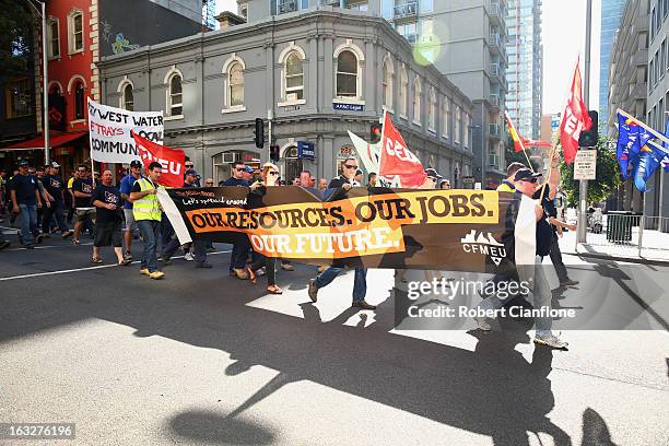 Workers walk through the city during a union organised protest against temporary worker visas on March 7, 2013 in Melbourne, Australia. As Australia...