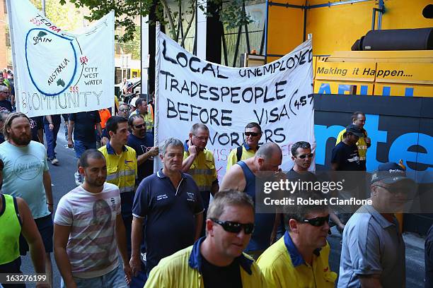 Workers walk through the city during a union organised protest against temporary worker visas on March 7, 2013 in Melbourne, Australia. As Australia...