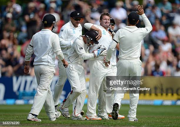 Bruce Martin of New Zealand celebrates with teammates after dismissing Matt Prior of England during day two of the First Test match between New...
