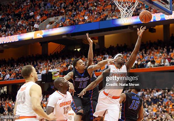 Fair of the Syracuse Orange goes up for a shot against Derrell Robertson of the DePaul Blue Demons during the game at the Carrier Dome on March 6,...