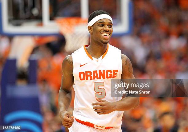 Fair of the Syracuse Orange smiles as he runs on the court in celebration after a play during the game against the DePaul Blue Demons during the game...