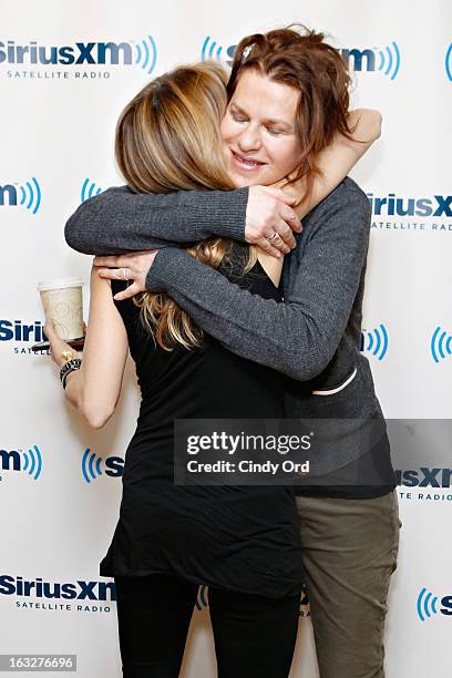 Singer Sheryl Crow surprises actress/ comedienne Sandra Bernhard during a visit to the SiriusXM Studios on March 6, 2013 in New York City.