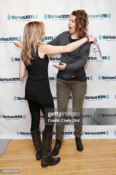 Singer Sheryl Crow surprises actress/ comedienne Sandra Bernhard during a visit to the SiriusXM Studios on March 6, 2013 in New York City.