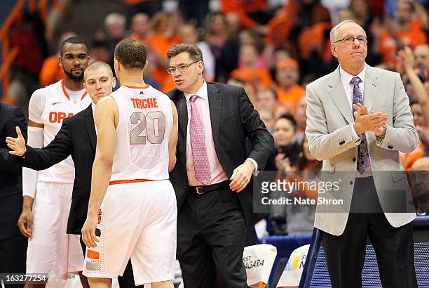 Head coach Jim Boeheim of the Syracuse Orange cheers as Brandon Triche exits the court, shaking hands with director of men's basketball operations...