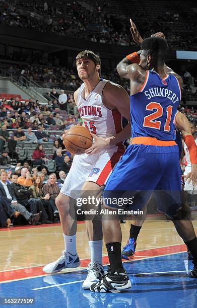 Viacheslav Kravtsov of the Detroit Pistons protects the ball from Iman Shumpert of the New York Knicks during the game between the Detroit Pistons...