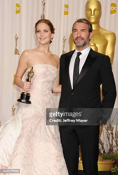 Jennifer Lawrence and Jean Dujardin pose in the press room during the 85th Annual Academy Awards at the Loews Hollywood Hotel on February 24, 2013 in...