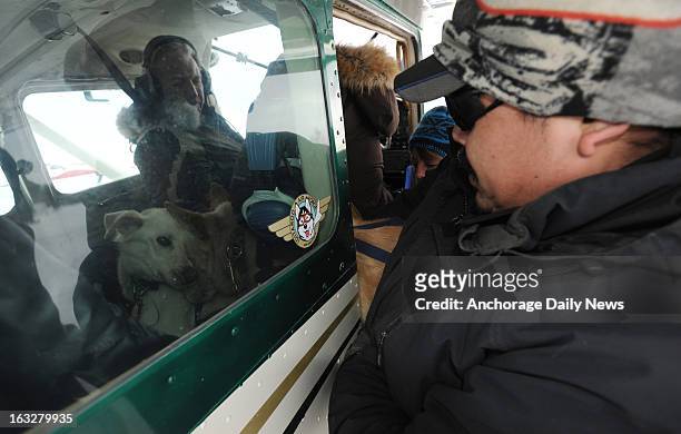 Iditarod Air Force pilot Danny Davidson, left, prepares to leave Nikolai airport with a load of dropped dogs on Wednesday, March 6 during the...