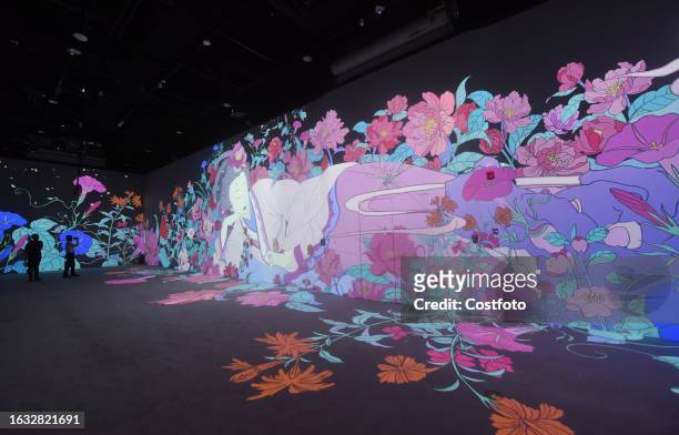 Visitors enjoy an immersive look at "digital ancient paintings" in the digital exhibition hall of the new Zhejiang Museum in Hangzhou, Zhejiang...