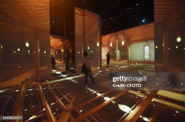 Visitors enjoy an immersive look at "Ancient Architecture" in the digital exhibition hall of the new Zhejiang Museum in Hangzhou, Zhejiang province,...