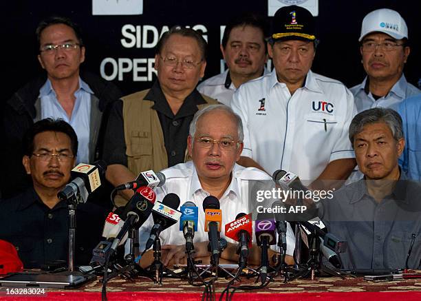 Malaysia's Prime Minister Najib Razak , accompanied by Malaysian Defence Minister Zahid Hamidi , speaks during a press conference in Felda Sahabat in...