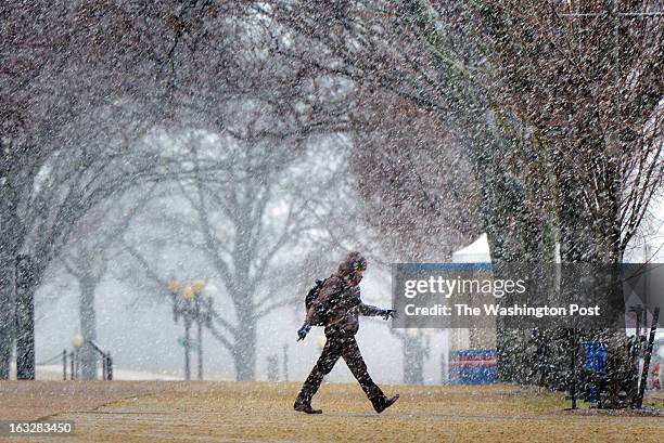 March 6: A pedestrian walks across the National Mall near 14th street as a major snowstorm descends on the region on March 2013 in WASHINGTON, DC.