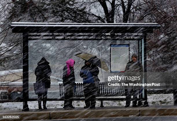 The bus shelter only provided so much protection from the storm as riders waited on Veirs Mill Rd. In Silver Spring. A slushy-wet snow storm hit the...