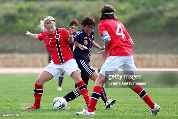 Asuna Tanaka of Japan challenges Lene Mykjaland of Norway and Ingvild Stensland of Norway action during the Algarve Cup match between Japan and...