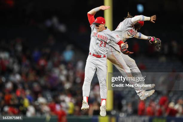 Friedl and Elly De La Cruz of the Cincinnati Reds celebrate after defeating the Los Angeles Angels at Angel Stadium of Anaheim on August 22, 2023 in...