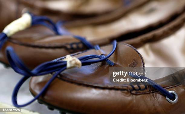 Leather ties sit bound on newly-manufactured leather shoes ahead of shipping at Tod's SpA's headquarters in Sant'Elpidio a Mare, near Civitanova...