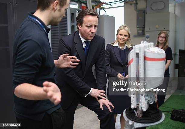 British Prime Minister David Cameron chats to Openreach apprentices as he tours a telephone exchange accompanied by Chief Executive of Openreach Liv...