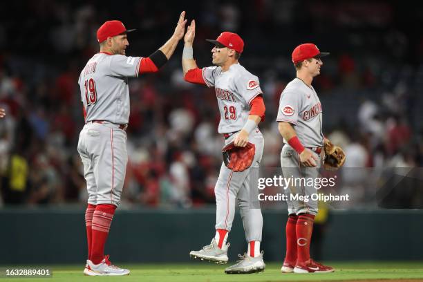 Joey Votto and TJ Friedl of the Cincinnati Reds celebrate their win over the Los Angeles Angels at Angel Stadium of Anaheim on August 22, 2023 in...