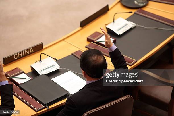 China's U.N. Ambassador, Li Baodong, votes at a U.N. Security Council meeting on imposing a fourth round of sanctions against North Korea in an...