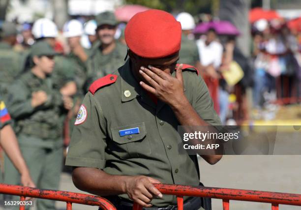 An honor guard cries during the funeral cortege of late Venezuelan President Hugo Chavez on its way to the Military Academy, on March 6 in Caracas....