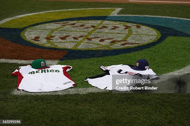 Team Mexico and Team USA jerseys are seen on the World Baseball Classic logo prior to the exhibition game between Team USA and the Colorado Rockies...