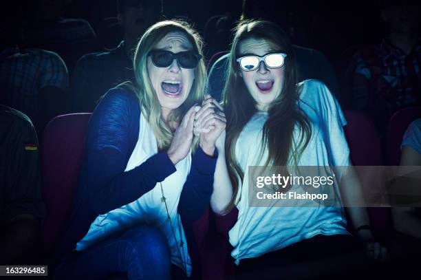 two girlfriends wearing 3d glasses at the movies - her film 2013 stock pictures, royalty-free photos & images