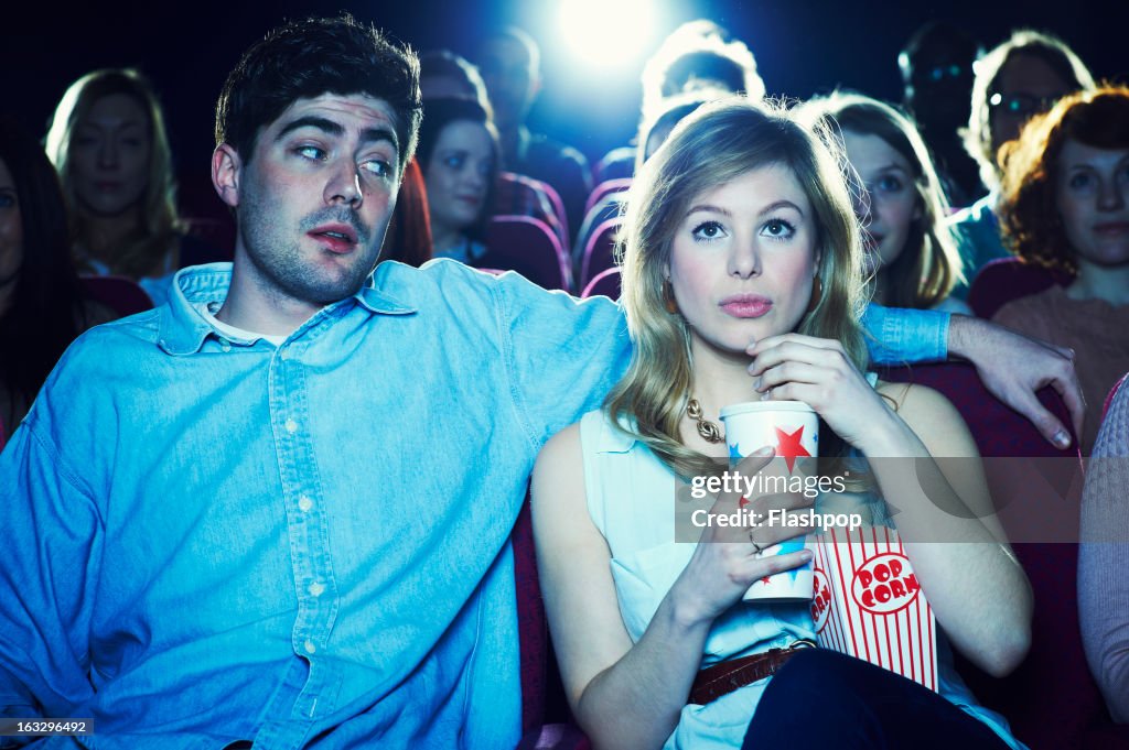 Couple enjoying a movie at the cinema