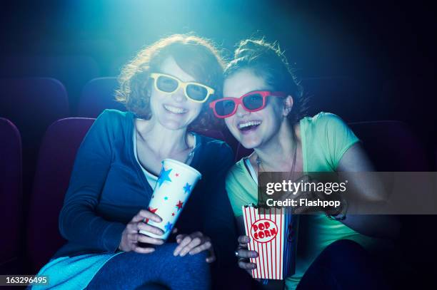 friends at the cinema wearing 3d glasses - 3d adult movie foto e immagini stock