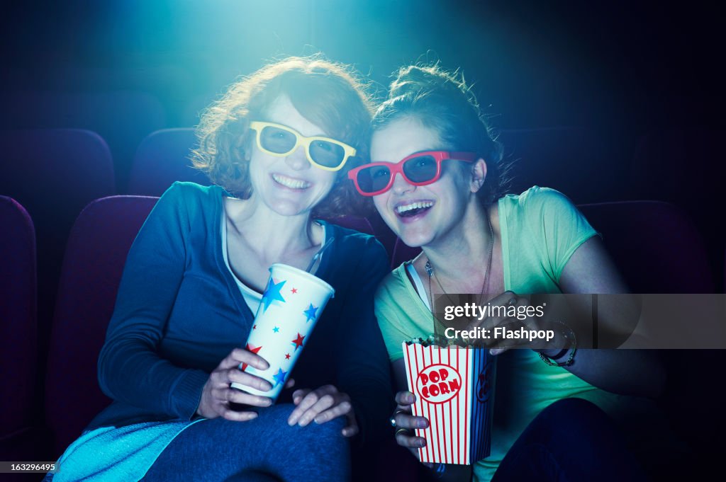 Friends at the cinema wearing 3D glasses