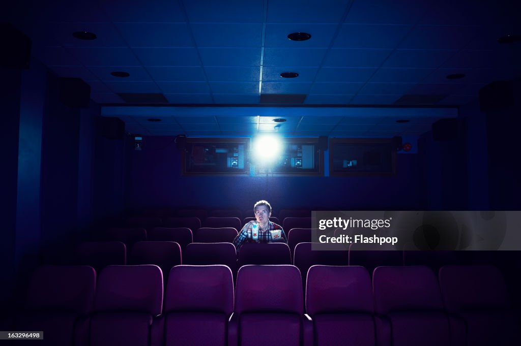 Man watching a movie in empty cinema