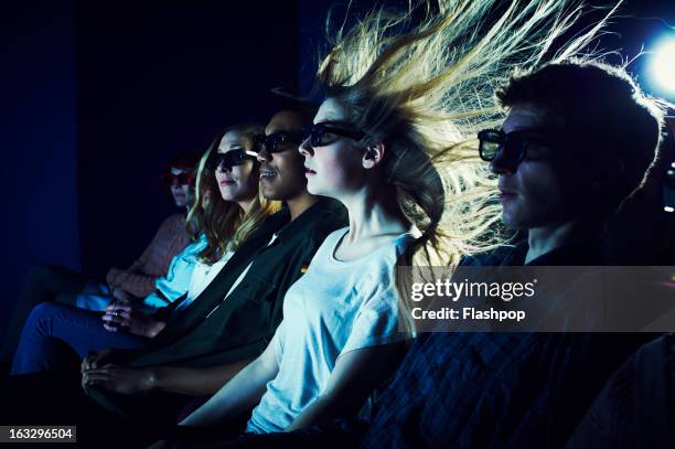 woman enjoying movie at cinema - sensory perception stock pictures, royalty-free photos & images