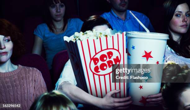 woman holding giant sized popcorn and drink - popcorn stock pictures, royalty-free photos & images